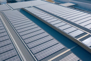 Solar panels or photovoltaic plant on the roof of a factory.